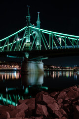 Budapest at night, Freedom Bridge on the Danube River, reflection of night lights on the water