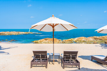 Beautiful tropical beach sea with umbrella and chair around white cloud and blue sky