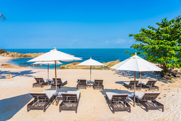 Beautiful tropical beach sea with umbrella and chair around white cloud and blue sky