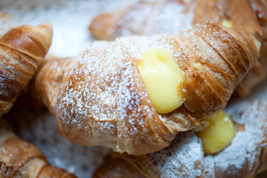 Freshly baked croissants on a plate with different fillings.