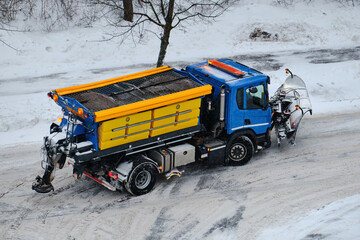Snowplow is clearing the street during a snowstorm in Finland.