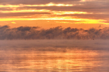 Fototapeta premium Fog over the Baltic sea during a strong frost in the sunset.