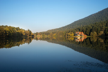 Wooden Lake house inside forest View of  Abant-Golcuk Lake. The collaboration of blue and green.  Amazing lake scenery. Golcuk National Park Bolu TURKEY