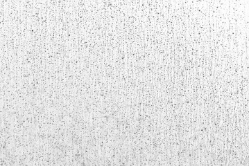 Black drops of dirt on a white background. Dirty wall after rain.