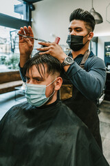 person wearing mask in barbershop