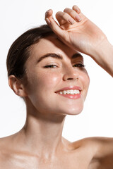 Beauty face of woman touch clean and fresh hydrated skin, perfect facial nude makeup and smile,...