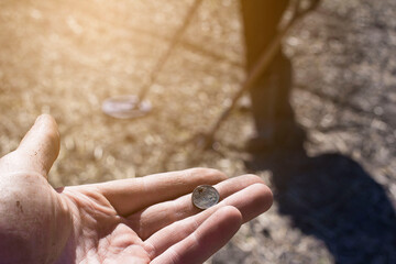 a man with a metal detector in the vast expanses of an old defensive fortress in search of ancient coins and artifacts, the foreground and background are blurred with bokeh effect