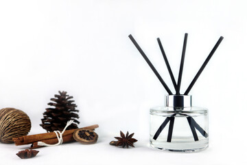 luxury aroma scent reed diffuser glass bottle is on white table with dried herb spice to creat romantic and relax ambient in the bedroom with white cement wall background on the happy valentine day