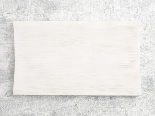 White wooden cutting board on white concrete background