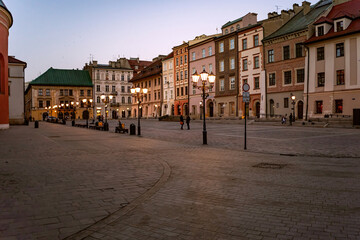 Fototapeta na wymiar Cracow Little Market Square in the evening, with lanterns already turned on. .