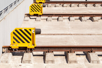 Stoppers and rusty rails on concrete sleepers
