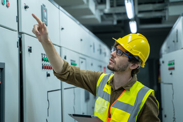 Industrial technician check voltage or current status in control panel of power plant electrical...