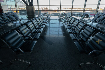 Several rows of seats in the airport's international terminal are completely empty. There are no passengers at the airport . No people at the airport during the covid 19 coronavirus pandemic.
