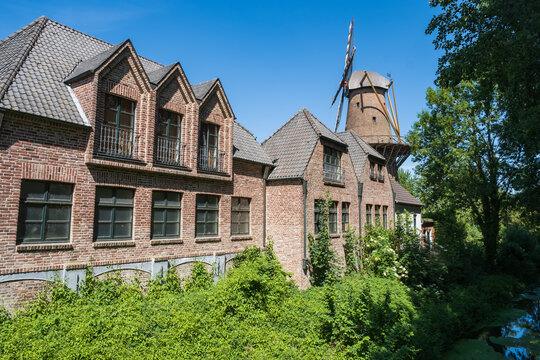View of brick houses and the mill of Kalkar / Germany in the background 