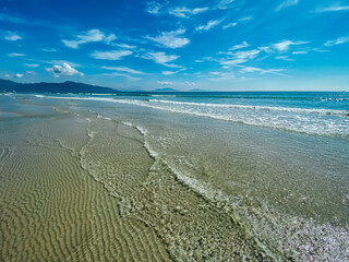Tropical vacation concept. Soft long waves on the tropical shore of a long empty sea beach. Caribbean coast