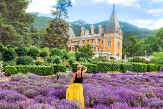 The girl in the lavender field on the background of the castle.