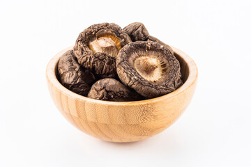 A lot of dried shiitake mushrooms in the wooden bowl
