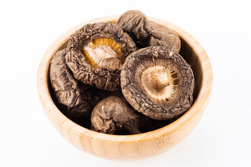 A lot of dried shiitake mushrooms in the wooden bowl