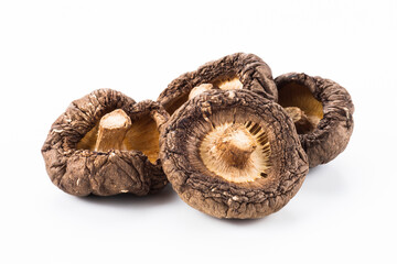Close-up of dried shiitake mushrooms isolated on white background.