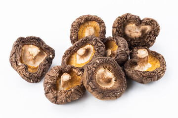 Close-up of dried shiitake mushrooms isolated on white background.
