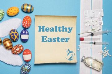 A medical banner with ECG, medicines and syringes with the Easter concept painted eggs and rabbit ears on a blue background with the inscription Healthy Easter.