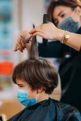 Fototapeta premium Boy With Protective Mask in Hair Salon
