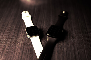 Pair of smartwatches in moody colors
