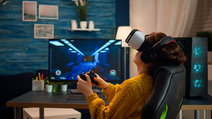 Professional gamer wearing virtual reality headset using wireless controller. Pro esport team...
