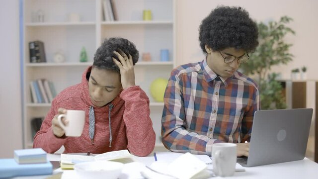 Lazy student falling asleep at table, nerd in eyeglasses studying hard education
