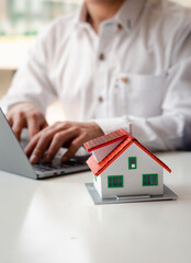 Home Loans, Home Loan Approval and Insurance Concepts, Businessmen are searching for a home online using a laptop computer.