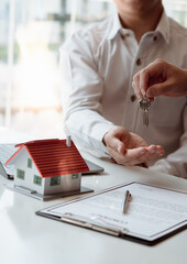 The insurance agent handed over the house key to the customer who agreed to buy the house after...