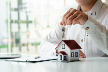 Real Estate Broker Home insurance or a home salesman holding a house key, Mortgage loan approval...