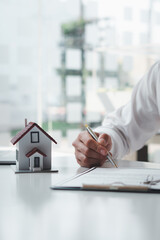 Customers interested in buying a home sign a signature to enter into a home purchase contract with...