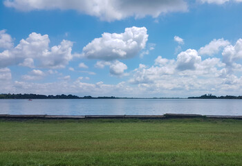 clouds over the lake and green grass