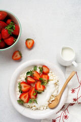 Cottage cheese, curd cheese with strawberries berries in a bowl, ogranic homemade dairy product. Healthy dairy product rich in Calcium and Protein.