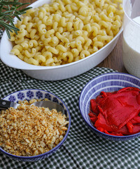 Tomato pasta Cavatappi bake in the making. Preparing oven-baked pasta with red peppers and breadcrumbs. 