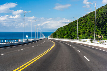 Fototapeta premium Asphalt road with blue sky in the countryside of Taitung, Taiwan.