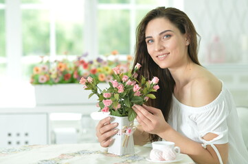 beautiful young woman posing with flowers