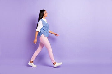 Fototapeta na wymiar Full length body size profile side view of attractive cheerful woman office worker walking isolated over violet purple color background