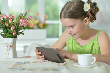 Portrait of  Beautiful little girl with tablet pc
