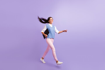 Fototapeta na wymiar Full length body size view of attractive cheerful woman walking carrying clipboard isolated over violet purple color background