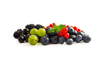 Mix berries isolated on white background. Blueberry, currant, gooseberry and blackberry with copy space for text. Mixed berries isolated on white. Heap of berries on white background.