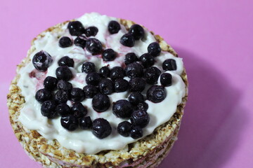 Healthy healthy food sandwich of yogurt bread and blueberry berries on lilac purple background