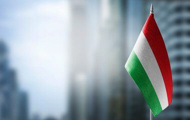 A small flag of Bulgaria on the background of a blurred background