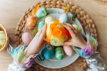 Kids hands with colorful easter eggs. Holidays, easter, traditions concept