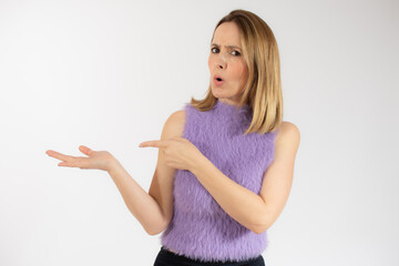 Young woman over isolated white background pointing fingers to the side