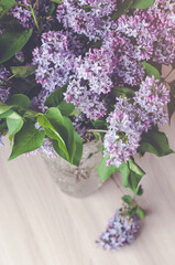 A bouquet of purple lilac in a glass vase.