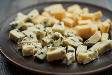 diced pigeon cheese on a plate close-up. background blurred