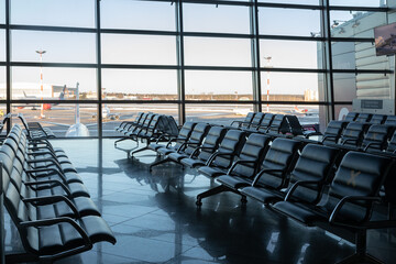 Several rows of seats in the airport's international terminal are completely empty. There are no passengers at the airport . No people at the airport during the covid 19 coronavirus pandemic.