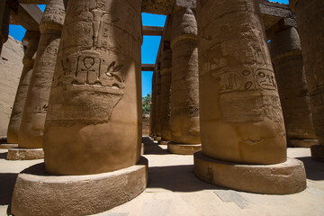 egyptian monument columns with ancient drawing on them 